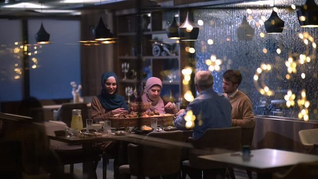 A diverse European Islamic family gathers together for iftar to break fasting during Ramadan, embracing cultural harmony and unity over Middle Eastern cuisine, warm lighting, Eid Mubarak dua time