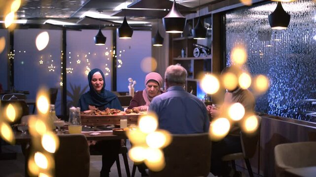A diverse European Islamic family gathers together for iftar to break fasting during Ramadan, embracing cultural harmony and unity over Middle Eastern cuisine, warm lighting, Eid Mubarak dua time