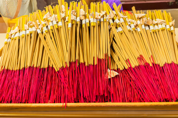 Close up a lot of incense wooden sticks for worship at the Buddhist temple. Religious tradition at...