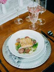 Captivating gourmet dish featuring salmon with fresh vegetables served elegantly in a restaurant setting