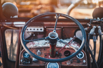 Abandoned old red tractor. Blue sky in background. Old tractor wreck.