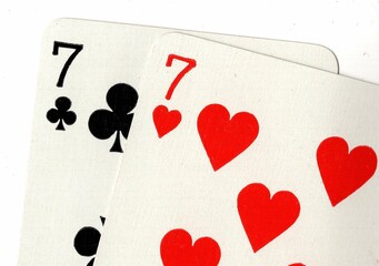 Close up of a hand of playing cards on a white background.