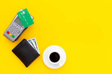 Paying a bill for a coffee at a cafe - bank payment terminal for payment by credit cards