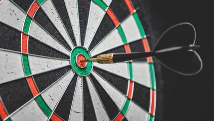 Dart hitting bullseye on target board