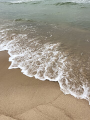 Wet sand and wave of sea. Natural background.