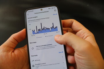 A person looking at internet statistics on his smartphone