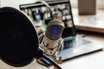 Radio broadcasting studio with podcast equipment: microphone and laptop