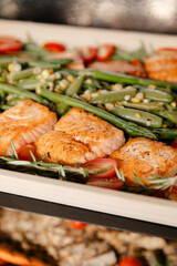 Delicious salmon and vegetable platter featuring fresh ingredients served at a dinner gathering in a cozy kitchen