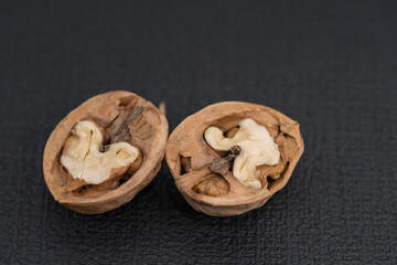 walnut and a cracked walnut isolated on the black background