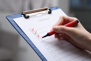 Woman filling Checklist on blurred background, closeup