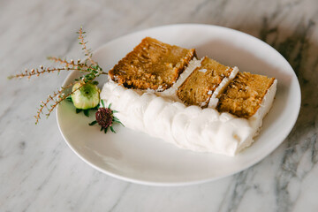 Delicious dessert featuring cake slices on a plate with decorative elements in a modern dining setting