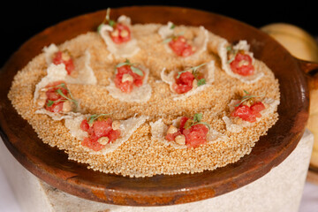 Unique culinary dish featuring delicate toppings served in a rustic wooden bowl with contrasting textures