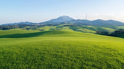Fototapeta premium Rolling green hills, mountain backdrop, wind turbines, scenic landscape, travel photography