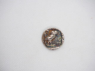 Greek silver coins, Athenian owl and Aegina turtle.