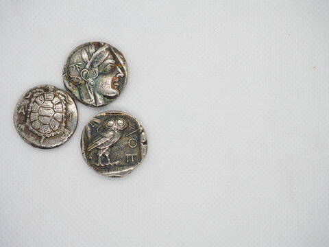 Greek silver coins, Athenian owl and Aegina turtle.