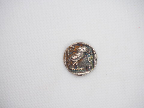 Greek silver coins, Athenian owl and Aegina turtle.