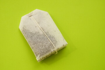 Tea bag on green table, copy space