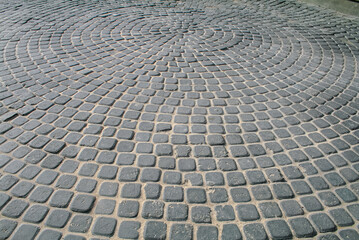 Fototapeta premium Patterned Cobblestone Pavement with Spiral Design in Urban Setting