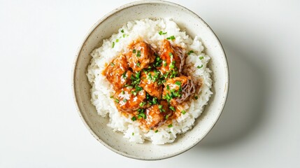 Freshly steamed rice topped with marinated chicken, presented against a plain white background. 