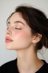 Fototapeta premium Side profile of a woman with luminous skin, natural glow reflecting light, neutral soft glam, aesthetic portrait photography captures her timeless beauty.
