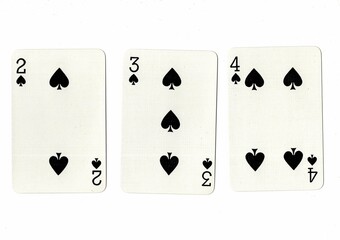 A hand of playing cards showing a run of three in the same suit.