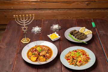 Menorah lighted candles in candlesticks with Star of David at set table chelnt