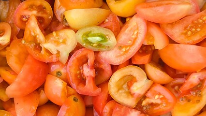 Sliced ​​tomatoes for background. Prepare tomatoes for cooking.