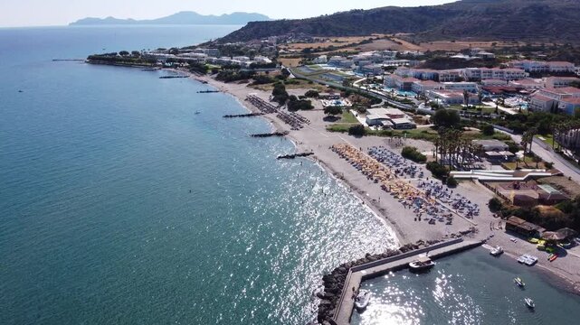 Spectacular aerial drone footage of Kos Island, Greece, featuring breathtaking views of Kefalos, Daidalos, Magic Beach, Exotic Beach, and Robinson Beach. Crystal-clear turquoise waters, dramatic cliff
