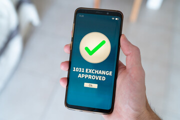 1031 exchange approved notification on smart phone.