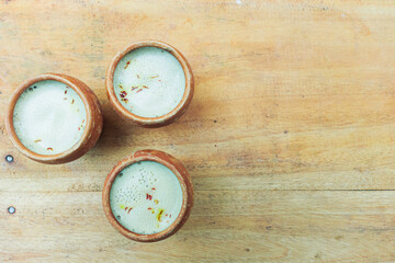 Three Clay Cups of Frothy Milk Tea Saffron Drink
