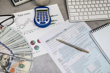 Fototapeta premium us 1040 tax forms, laptop keyboard and calculator money dollar bills, business tax time concept