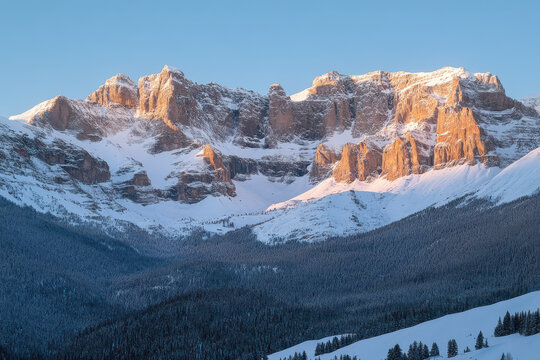 A snow-covered mountain range at dawn