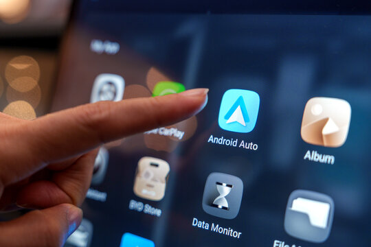 Penang, Malaysia - Feb 22, 2025: Close-up of a hand interacting with the Android Auto app on the BYD car's digital display, highlighting advanced in-car technology at the Penang auto show.