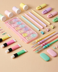 Naklejka premium Stationery and supplies for drawing and crafts. Watercolor, gouache, acrylic paints, brushes, pencils on beige background