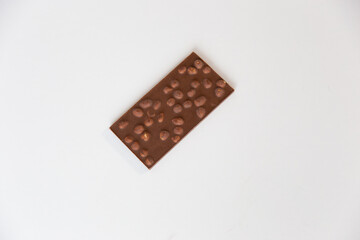 whole milk chocolate bar with nuts at the bottom, on a white background