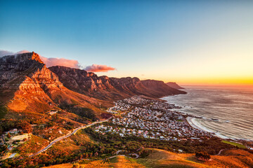 Cape Town Sunset over Camps Bay Beach with Table Mountain and Twelve Apostles in the Background