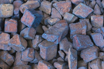 Natural blue nila pure indigo dye stones close up at traditional oriental street souk as background.