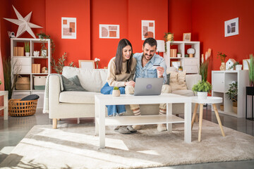 man and woman use credit card and laptop for online shopping at home