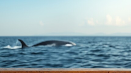 Fototapeta premium A blurred whale swims in blue ocean water during daytime