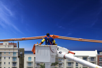 Electrical line worker in a crane