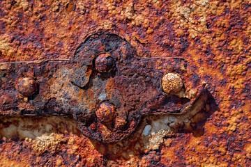 Macro Close-up details of a rusted door hinge and door on the Point Wilson Coastal Lighthouse just...