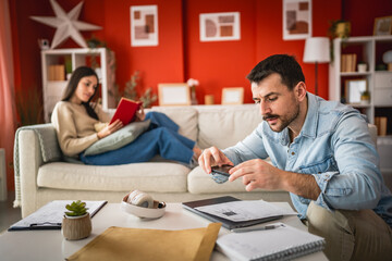 man use mobile phone for contacless payment in the living room