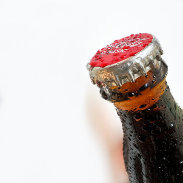 Coca-Cola brand red cap and cold drink on white background