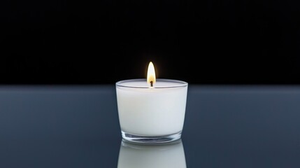 Single white candle flame on reflective surface