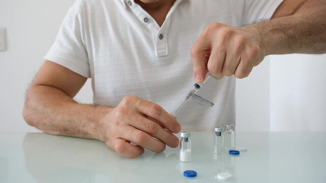 49 year old Brazilian man diluting growth hormone medication to be administered.