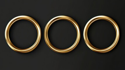 Three golden metal rings on black background: circular gold objects with reflections