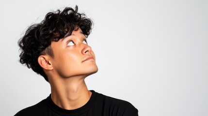 "Man standing against light background with a surprised or curious expression."