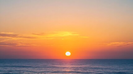 Serene ocean sunset with vibrant orange and yellow hues.