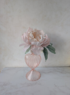 pink flower in a vase on the table