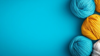 Colorful yarn balls arranged on a vibrant blue background, ideal for crafting projects and creativity